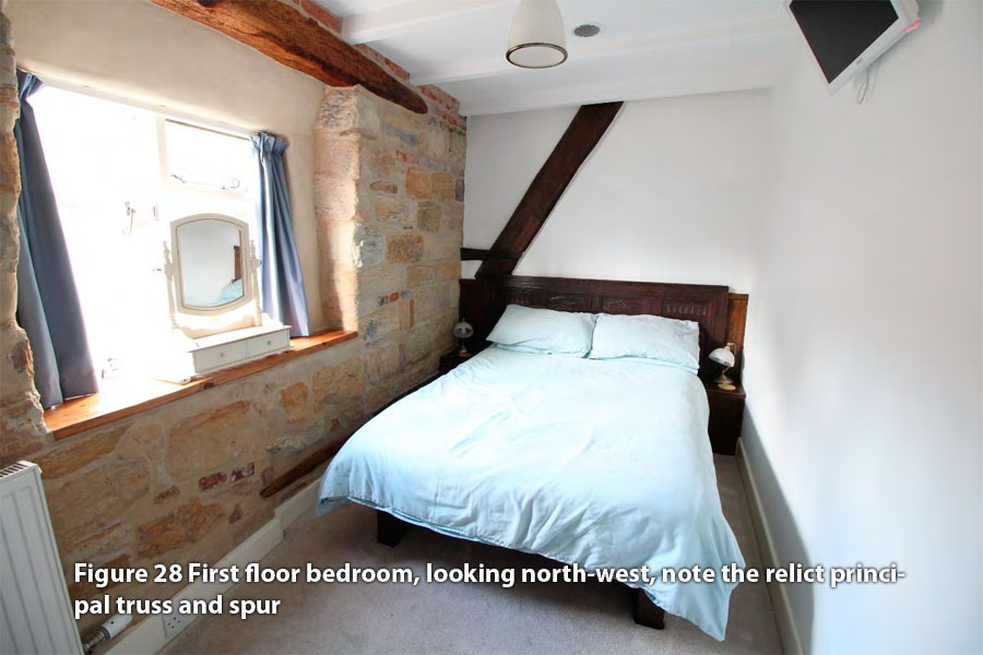 Figure 28 First floor bedroom, looking north-west, note the relict principal truss and spur